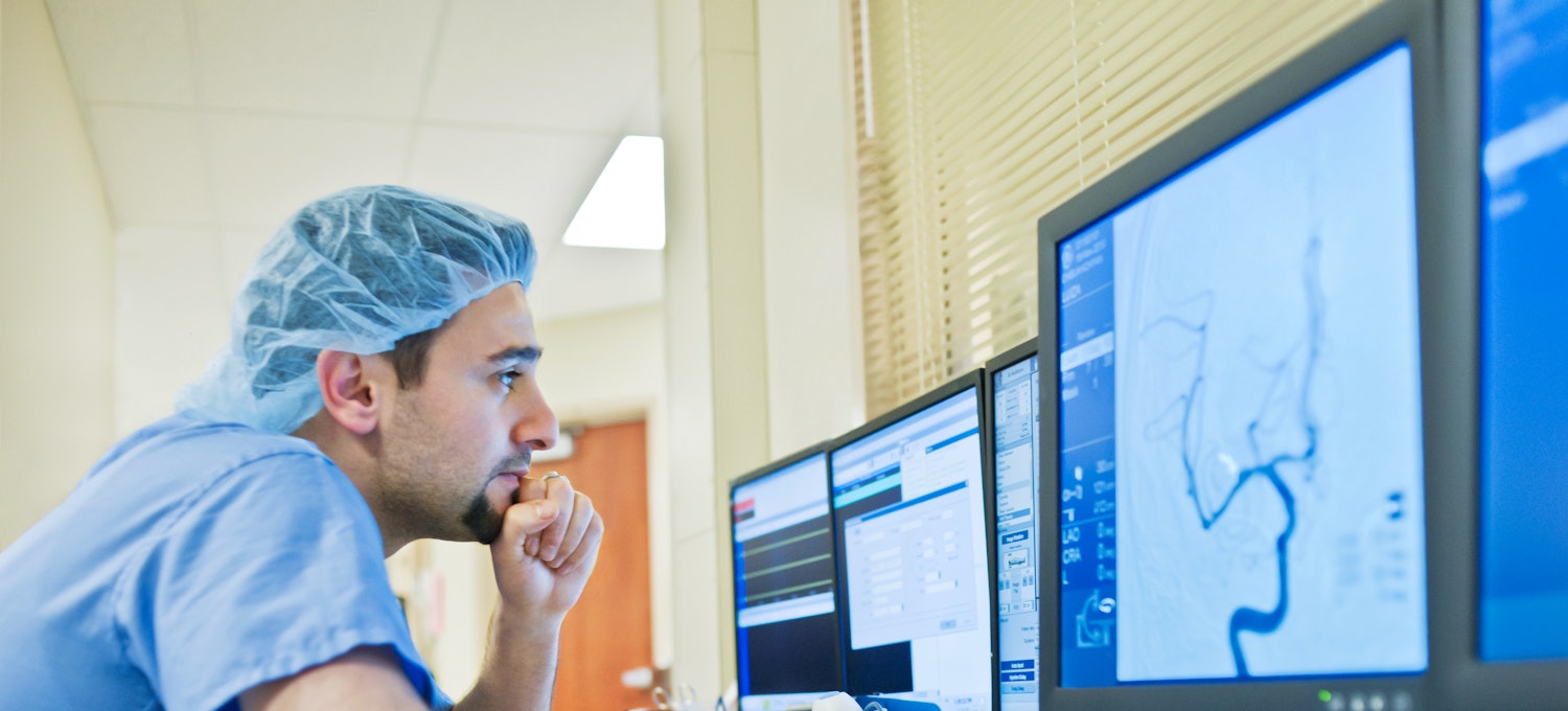 [Featured Image]: Health Informatics specialist analyzing patients' data. 